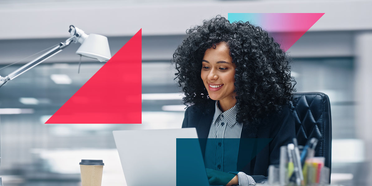 a woman is sitting at a desk using a laptop computer